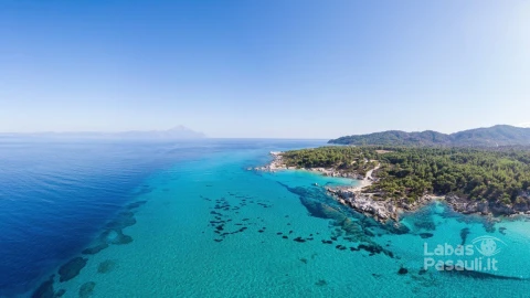 wide-shot-aegean-sea-coast-with-blue-transparent-water-greenery-around-pamorama-view-from-drone-greece_1268-16775