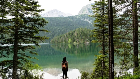 female-with-backpack-enjoying-view-black-lake-durmitor-national-park-montenegro