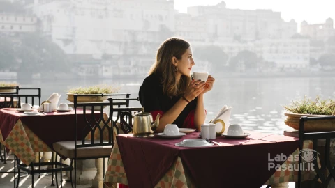 western-woman-having-teatime-cafe-udaipur-min