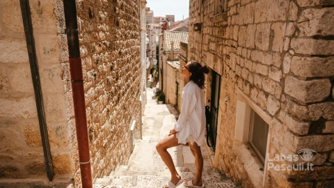 young-girl-walking-through-ancient-narrow-streets-beautiful-summer-day-min