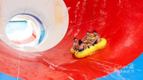friends-having-fun-huge-water-slide-aqua-park-min