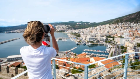 woman-looking-into-stationary-binocular-kavala-greece-min