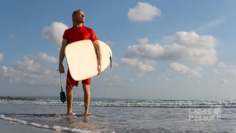 surfer-walking-along-beach-bali-min