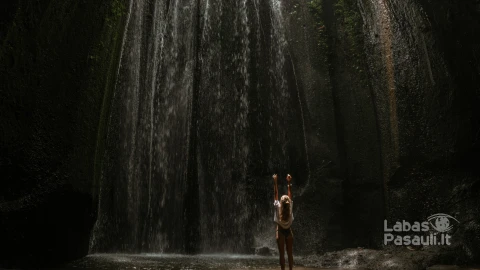 young-woman-waterfall-rock-bali-indonesia-min